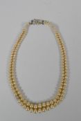 A vintage graduated faux pearl twin strand necklace, 38cm long