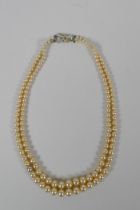 A vintage graduated faux pearl twin strand necklace, 38cm long