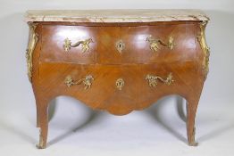 A French bombe shaped two drawer kingwood commode, with ormolu mounts and marble top, raised on