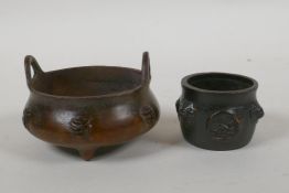 A Chinese bronze two handled censer on tripod supports with character decoration, Xuande 6 character