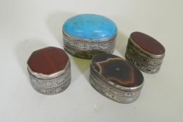 Three white metal pill boxes with inset agate tops, largest 4.5cm long, and another with turquoise