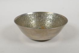 An Islamic white metal bowl, with all over script decoration, 12cm diameter, 117g