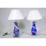 A pair of Murano style blue glass table lamps with swirled and aventurine decoration, mounted on