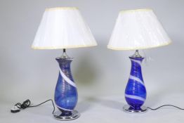 A pair of Murano style blue glass table lamps with swirled and aventurine decoration, mounted on