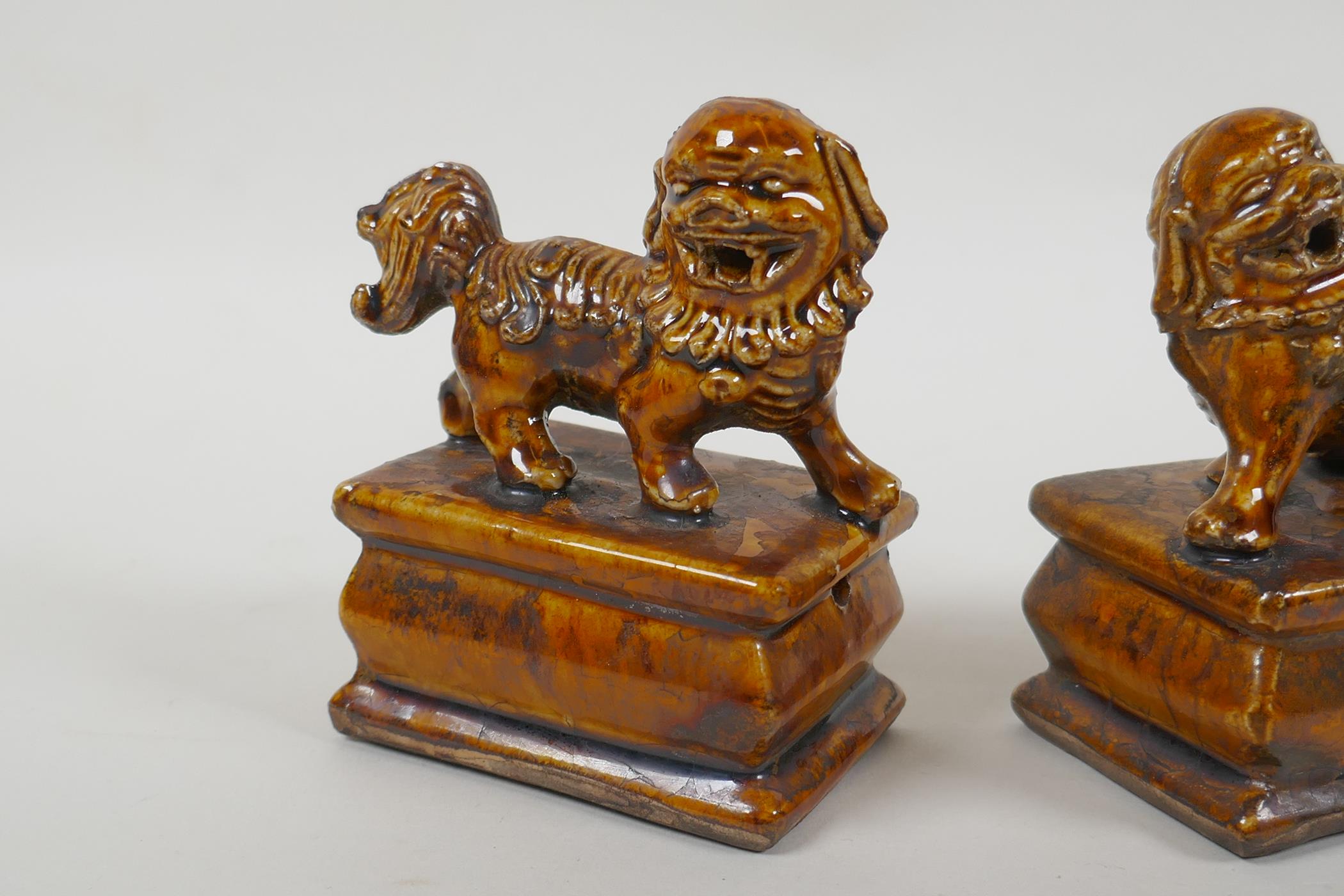 A pair of Chinese ochre glazed porcelain fo dogs, 10cm high - Image 3 of 5