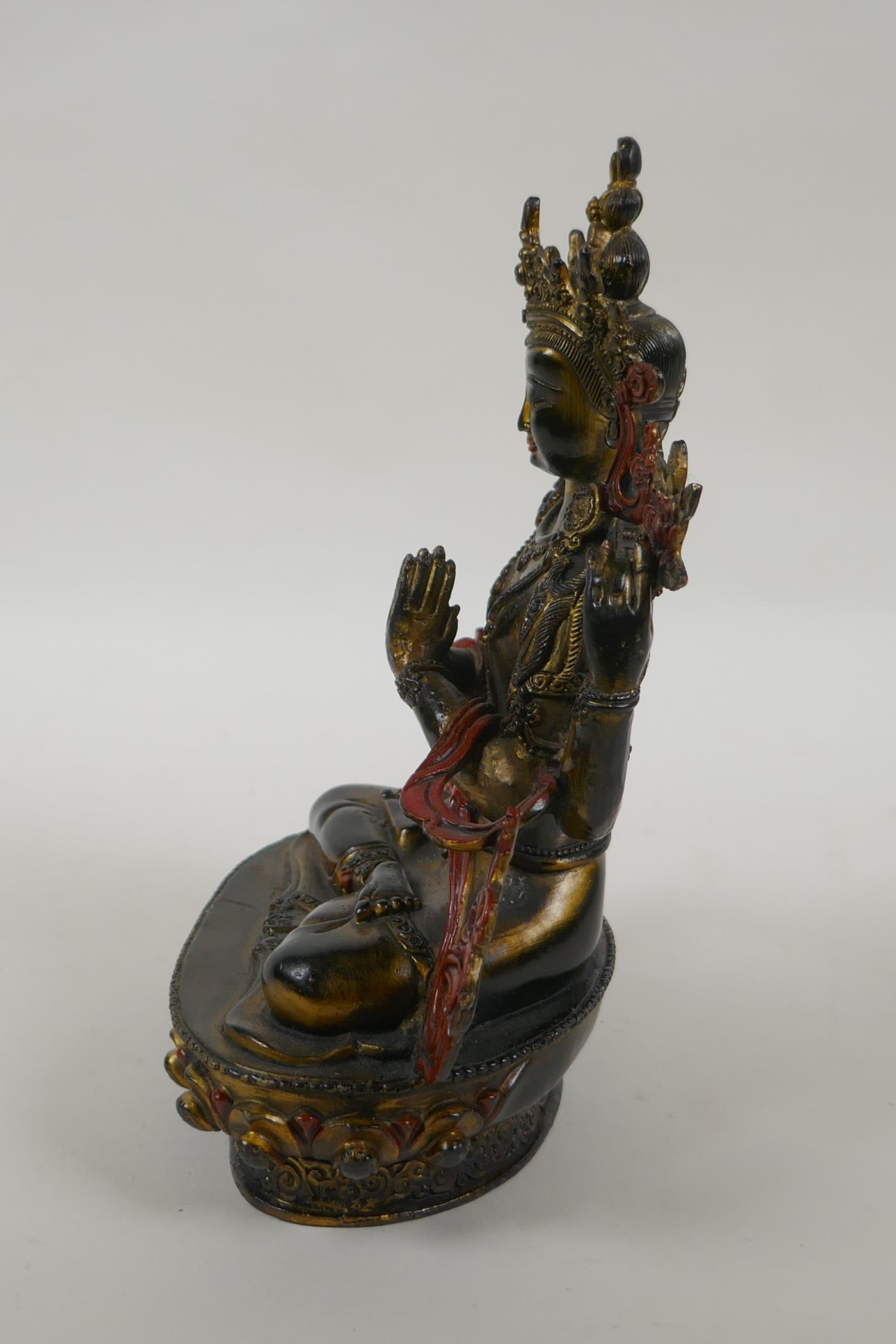 A Tibetan bronze figure of the Buddhist deity Chenrezig, with gilt and painted details, 21cm high - Image 3 of 4