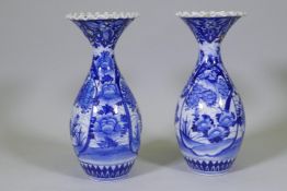 A pair of Arita blue and white vases with flared necks and frilled rims, AF repairs to necks, 45cm