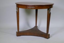A late C19th Empire style French mahogany gueridon with brass mounts raised on tapering supports