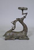 An Eastern patinated bronze censer in the form of a deer, 33cm high
