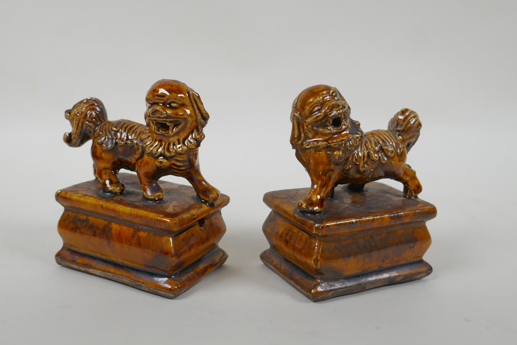 A pair of Chinese ochre glazed porcelain fo dogs, 10cm high