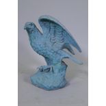 A metal figure of an eagle with verdigris patination, 45cm high