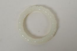 A carved white hardstone bangle, 7.5cm diameter