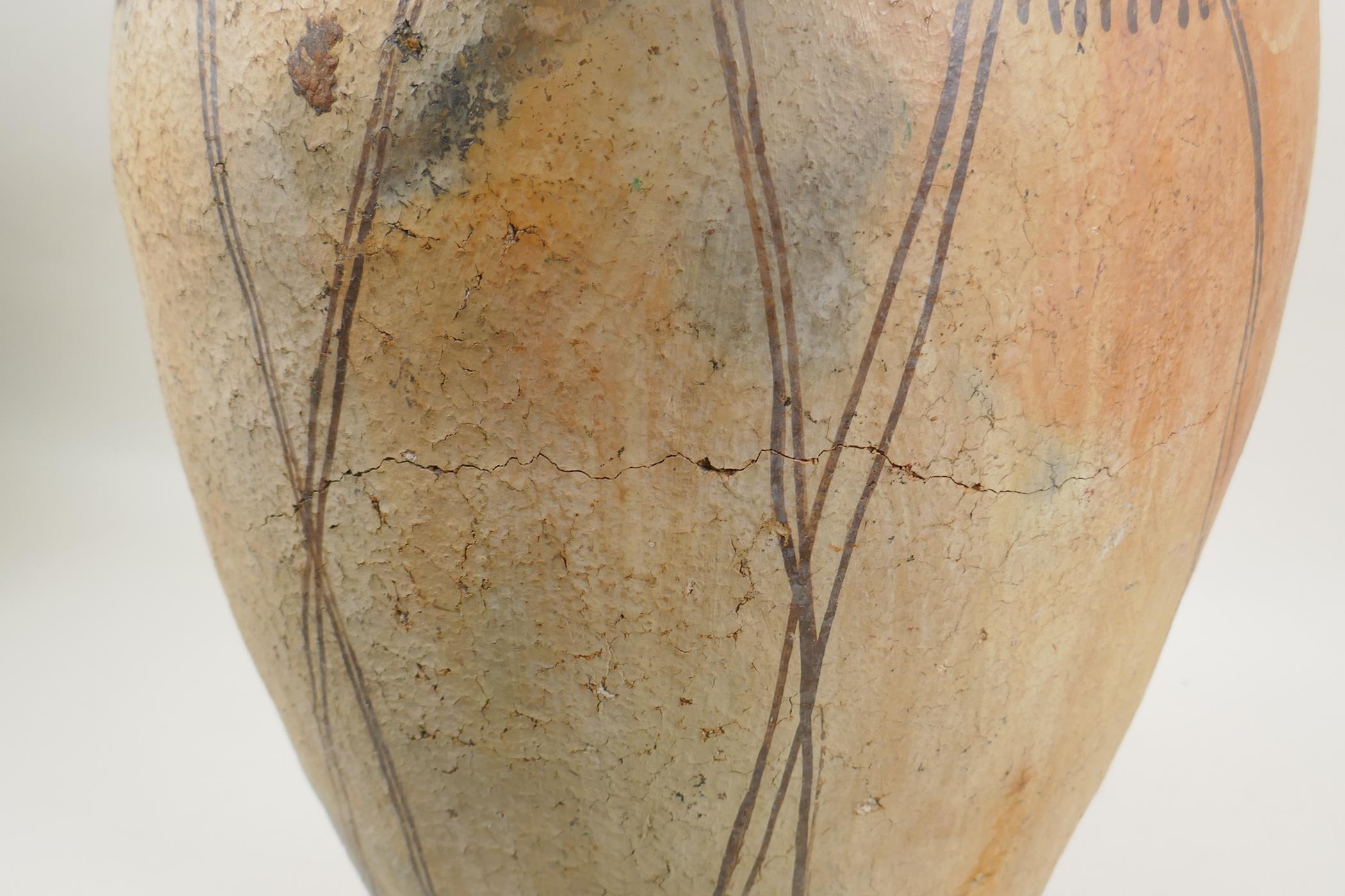 An antique North African terracotta amphora with two handles and hand painted design, AF, 63cm high - Image 6 of 6