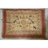 A C19th Indian embroidered wall hanging decorated with depictions of Ganesh, peacocks, elephants,