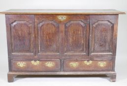 A C19th North Country oak four panel mule chest, adapted with two cupboards over two drawers, and