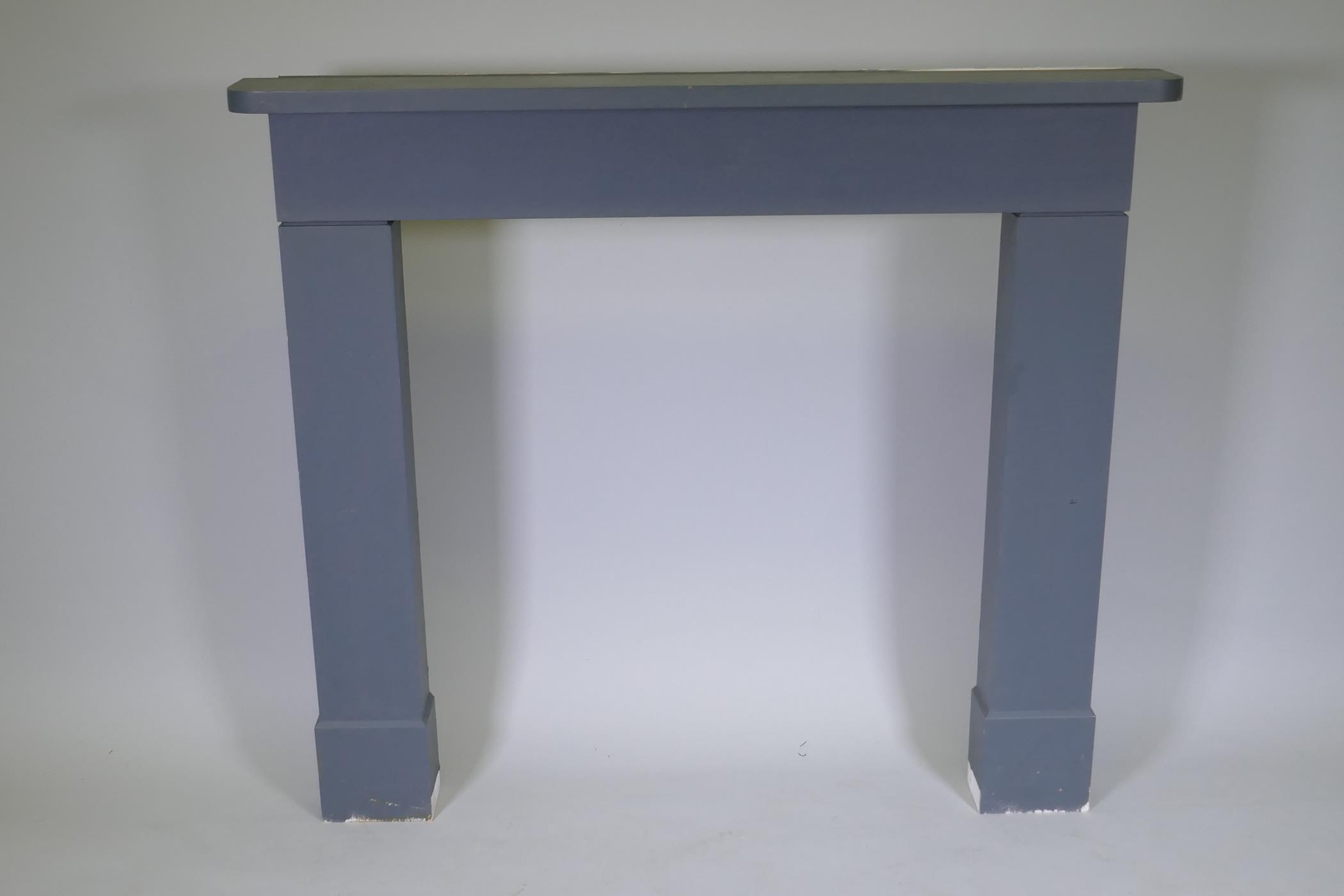 A painted wood fire surround, 131cm wide, 115cm high