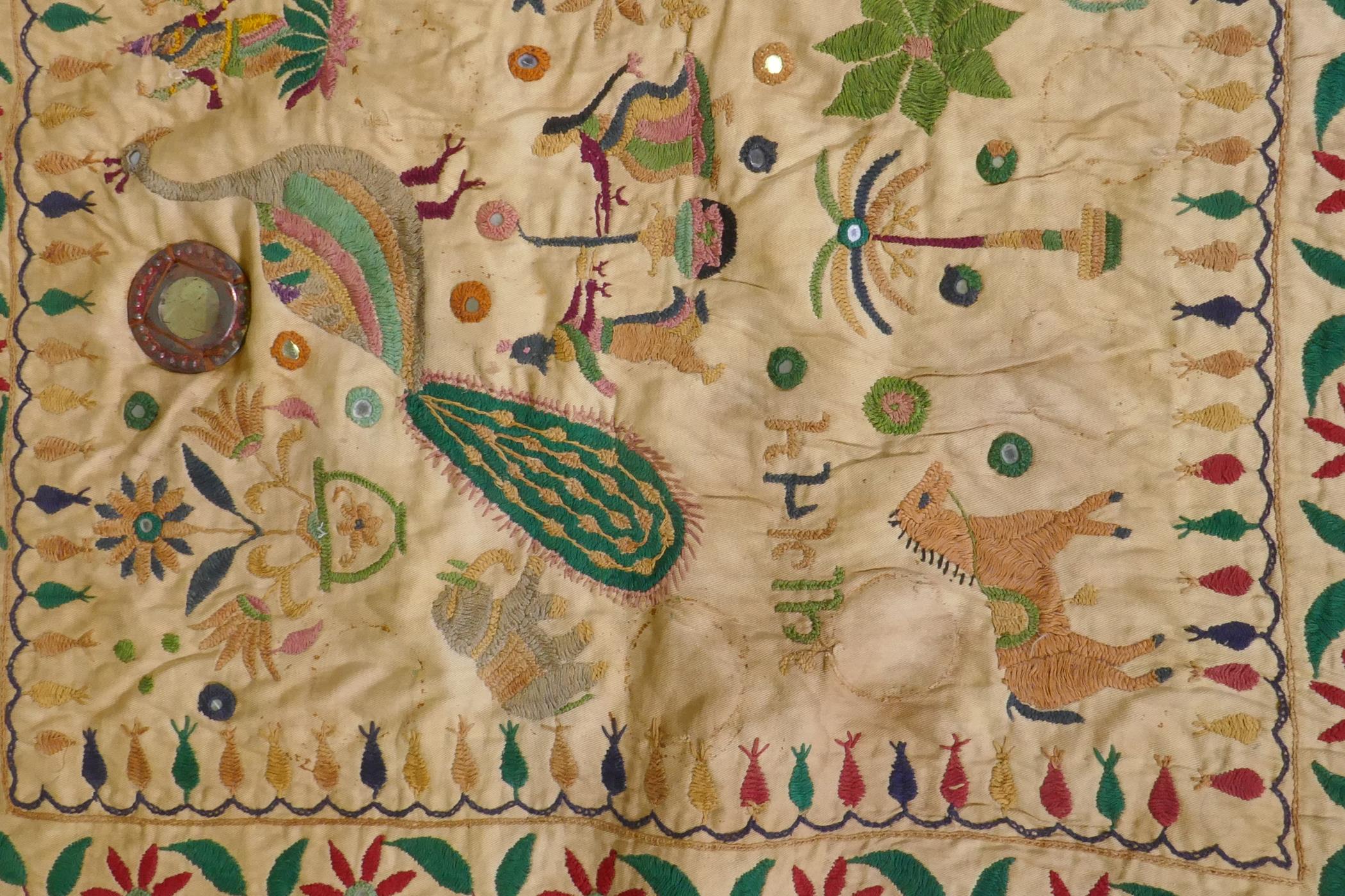 A C19th Indian embroidered wall hanging decorated with depictions of Ganesh, peacocks, elephants, - Image 4 of 9