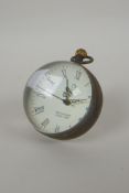 A brass bound glass ball clock, 6cm diameter