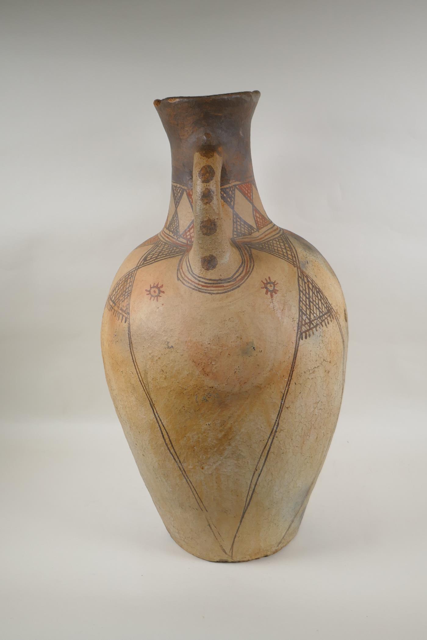 An antique North African terracotta amphora with two handles and hand painted design, AF, 63cm high - Image 4 of 6