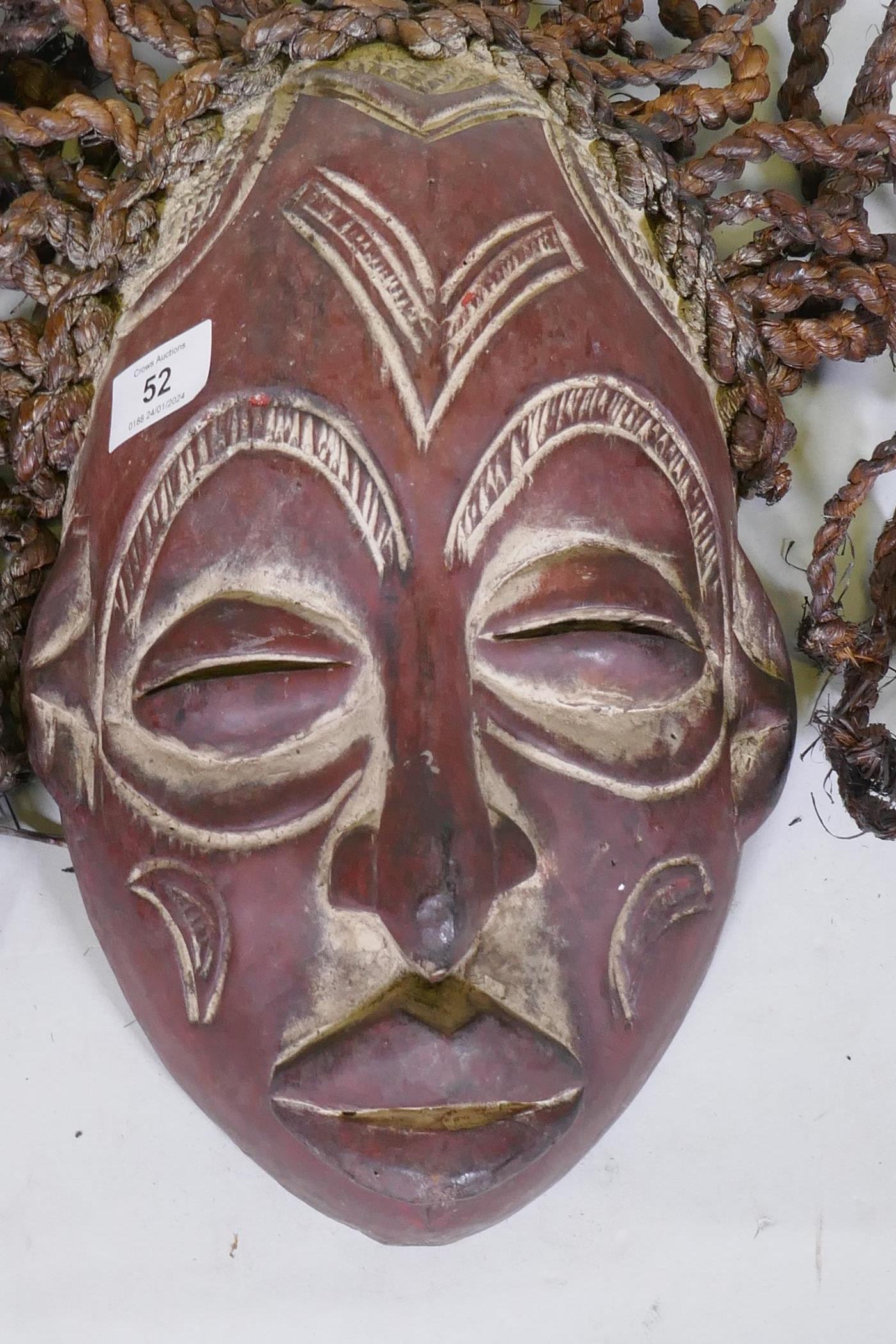 An African tribal carved and painted wood mask with braided straw decoration - Image 2 of 5