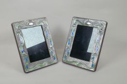 A pair of sterling silver and enamel Art Nouveau style photo frames, 9 x 14cm aperture