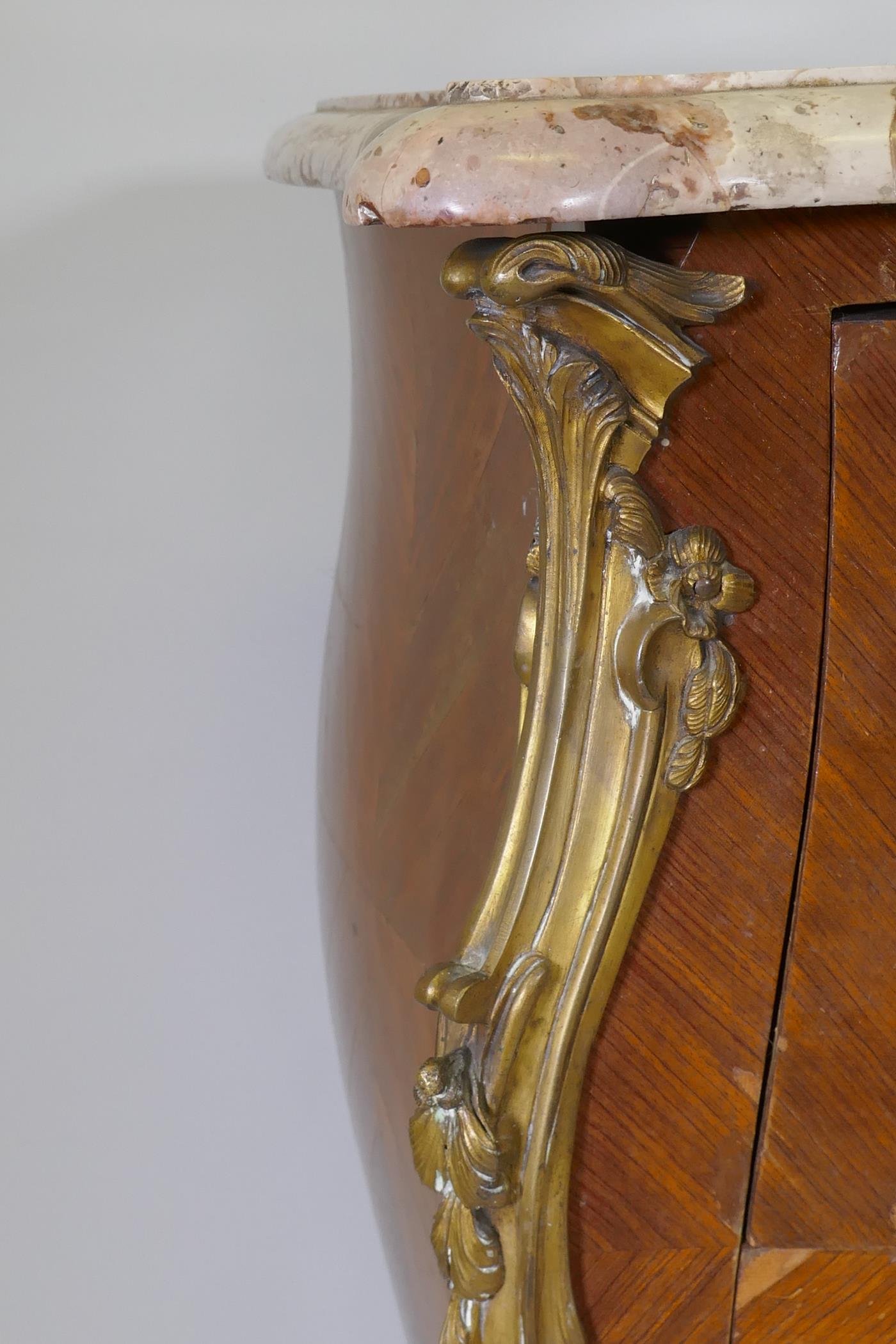 A French bombe shaped two drawer kingwood commode, with ormolu mounts and marble top, raised on - Image 4 of 6