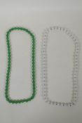 An apple green jade bead necklace, and a similar white jade bead necklace, longest 70cm