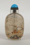 A Chinese reverse decorated glass snuff bottle decorated with figures and buffalo in a landscape,