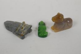 A Chinese apple green jade carved Buddha pendant, an agate carving of a horse and a carved hardstone