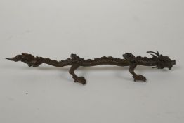 A Japanese style bronze okimono dragon, 16cm long