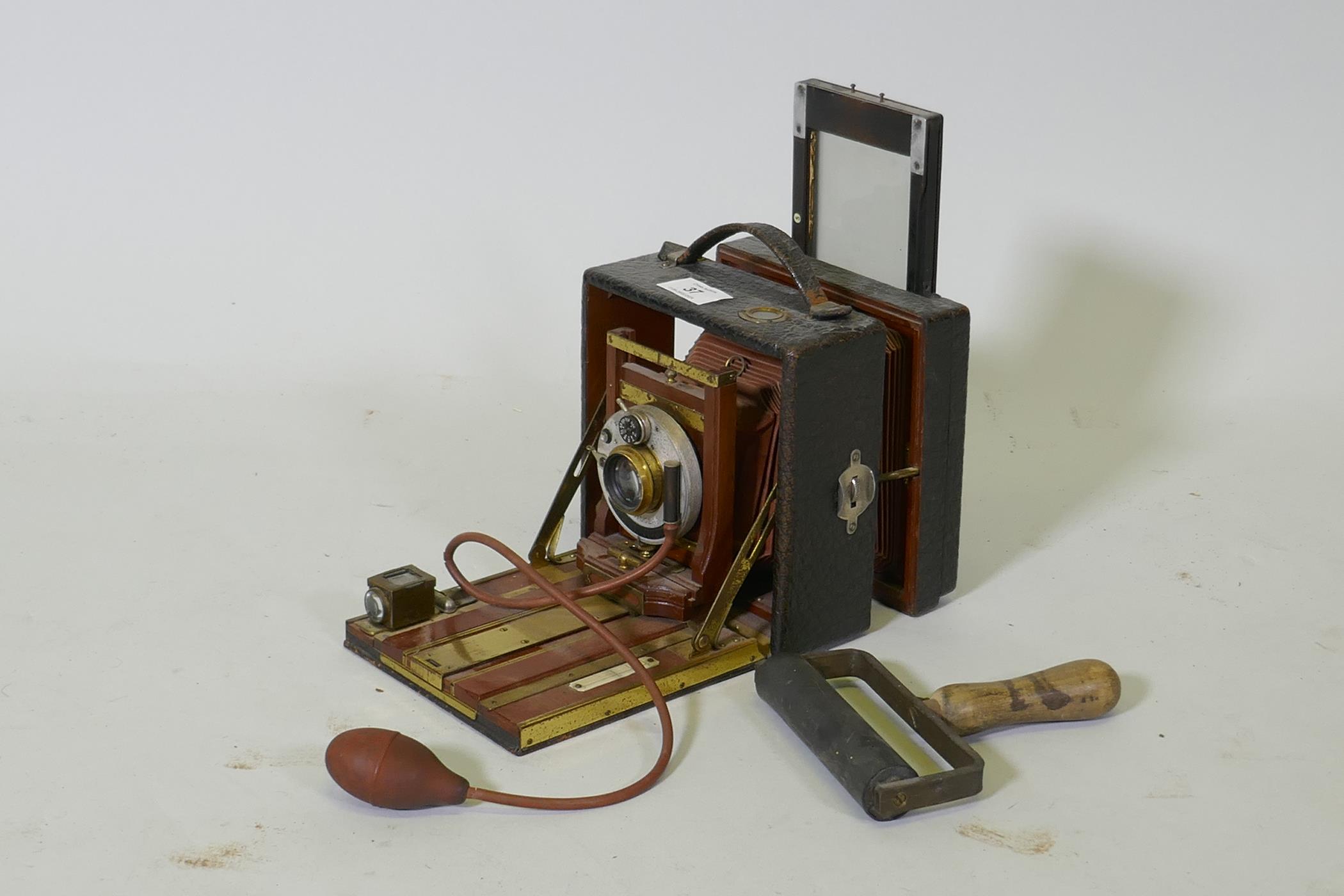 A Victorian bellows camera mahogany with brass mounts, in leather covered case, Koilos shutter and