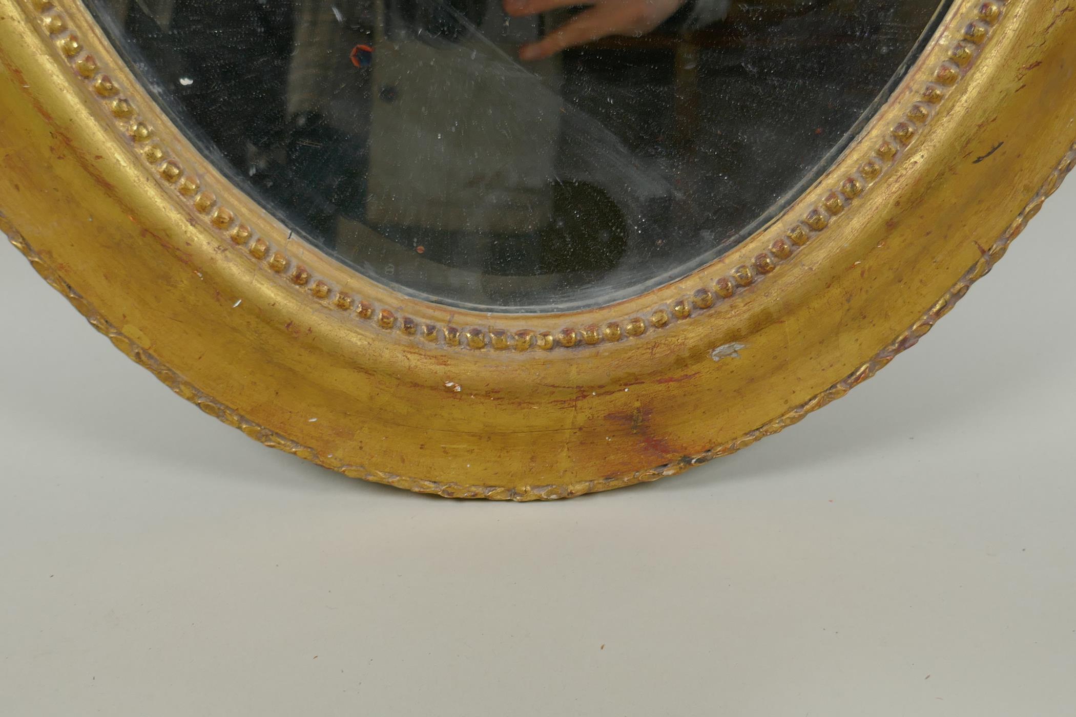 An antique French oval gilt mirror, with bevelled antique glass, 53 x 87cm - Image 6 of 8