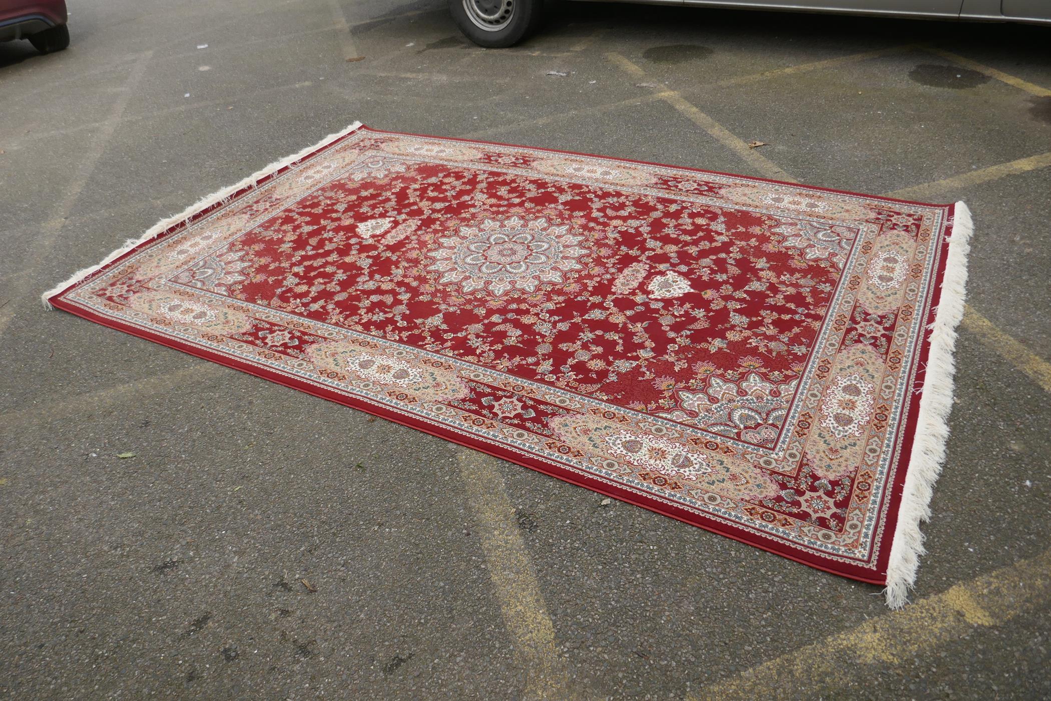 A fine woven full pile rich red ground Qom carpet, with floral medallion design and floral - Image 2 of 5