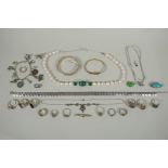 A quantity of vintage silver costume jewellery to include rings, charms, bangles etc, mostly all