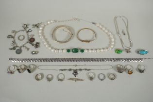 A quantity of vintage silver costume jewellery to include rings, charms, bangles etc, mostly all