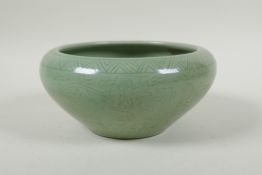 A Chinese olive green glazed porcelain dish with incised scrolling floral decoration, 19cm diameter