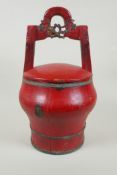 A Chinese red lacquered wood food carrier, 36cm high