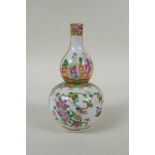 A C19th Chinese Canton famille rose porcelain double gourd vase, with decorative panels depicting