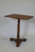 A C19th mahogany occasional table raised on a barleytwist column and platform base, with bun feet,