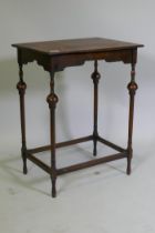 A Queen Anne style oak lamp table, raised on slender supports with baluster shaped detail, 50 x 38 x