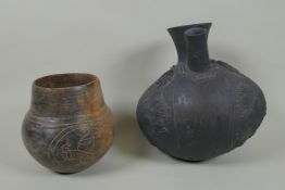 A Peruvian Chimu style Blackware double spout vessel, and another South American pottery vase,
