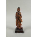 A Chinese carved boxwood figure of a bearded sage, 15cm high