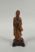 A Chinese carved boxwood figure of a bearded sage, 15cm high