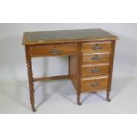 A Victorian mahogany five drawer desk, with leather inset top, raised on turned supports with