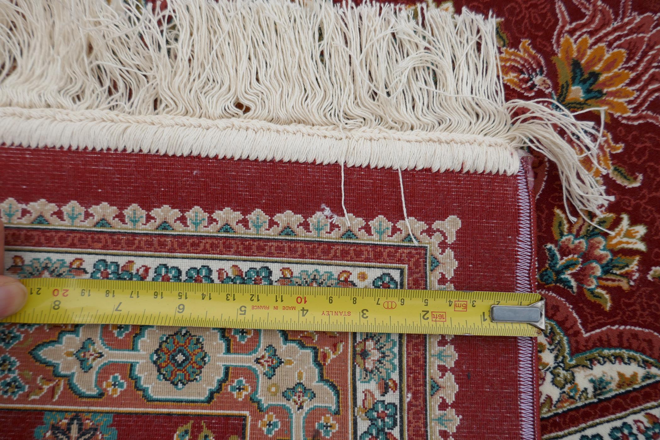 A fine woven full pile rich red ground Qom carpet, with floral medallion design and floral - Image 5 of 5