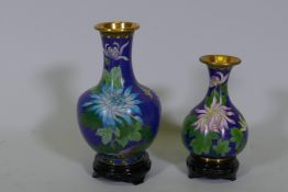 Two Chinese cloisonne vases, floral decoration on a blue ground, with wood stands, late C20th,