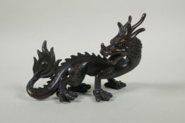 An oriental bronze figure of a dragon, 15cm long