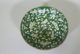 A vintage green glazed Chinese bowl with prunus blossom decoration, 24.5cm diameter