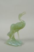 A Chinese green jade carving of a crane, 16cm high