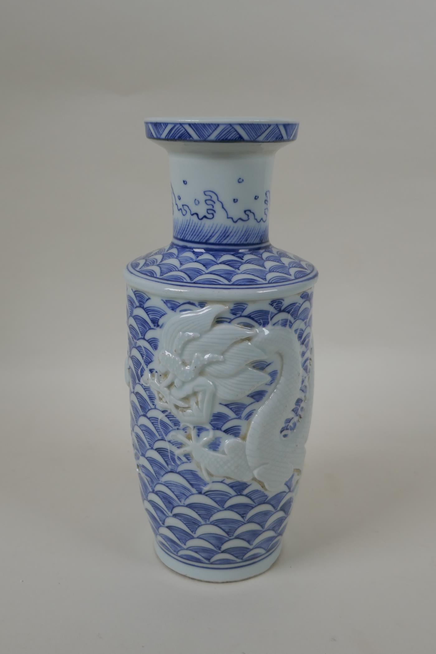 A Chinese blue and white porcelain vase with raised dragon decoration, impressed mark to base,